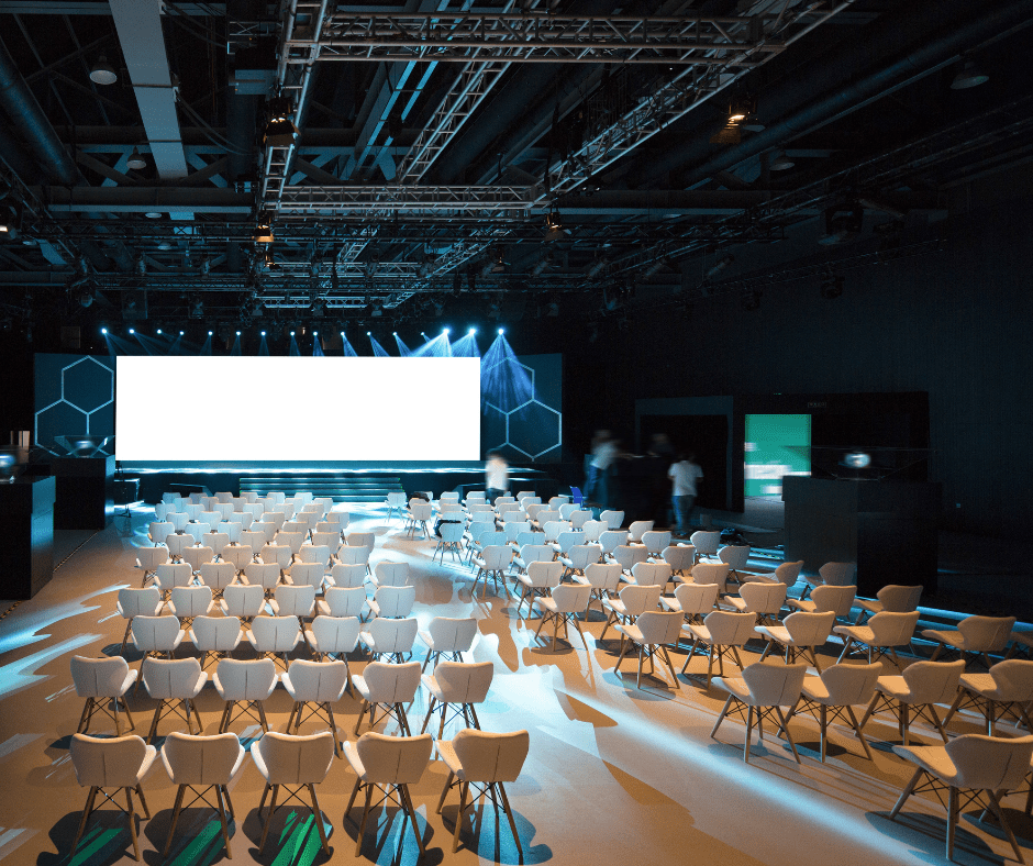 conference room, white chairs, large screen, conference setup