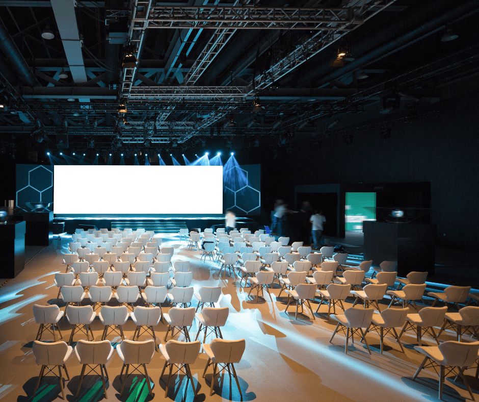 conference room, white chairs, large screen, conference setup